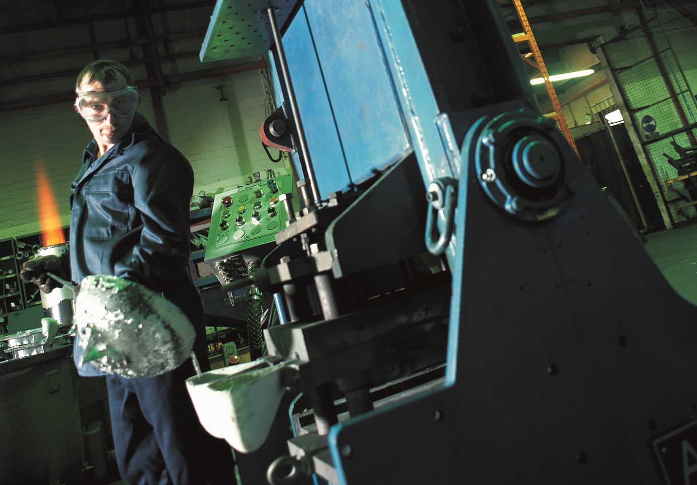 A man pours molten aluminium into a mould